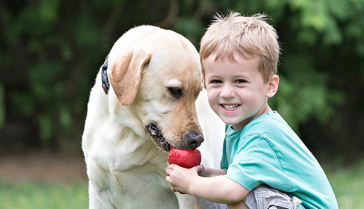 Pohtograph of a joung child and his dog
